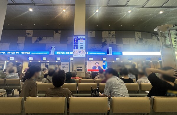 의협 주도 휴진이 실시된 18일 삼성서울병원을 찾은 내원객들이 휴진 관련 윤석열 대통령의 국무회의 발언을 청취하고 있다.<br>